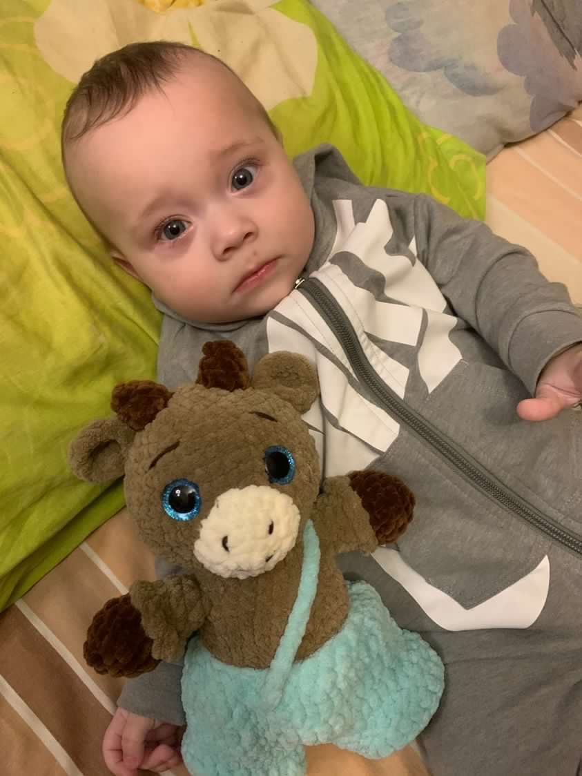 Baby sleeping peacefully with a handmade crochet deer